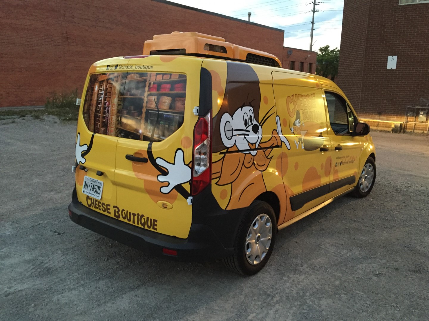 Cheese Boutique delivery van with yellow cartoon vehicle graphics