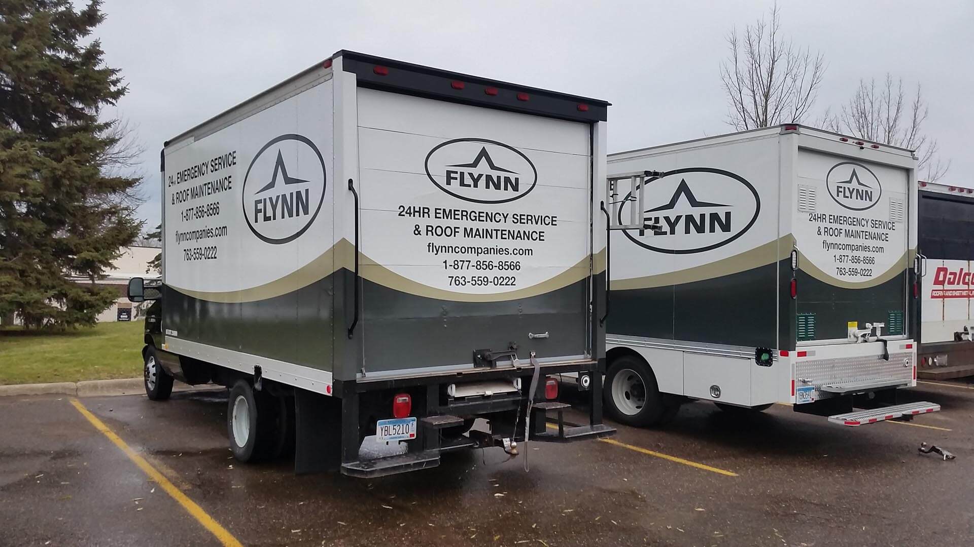 Two cube tracks wrapped in the same fleet graphics to create branding on the company's commercial vehicle fleet