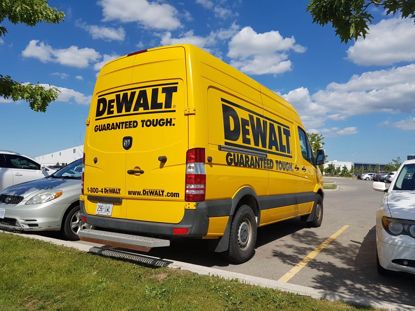 A parked commercial van branded with commercial van wrap