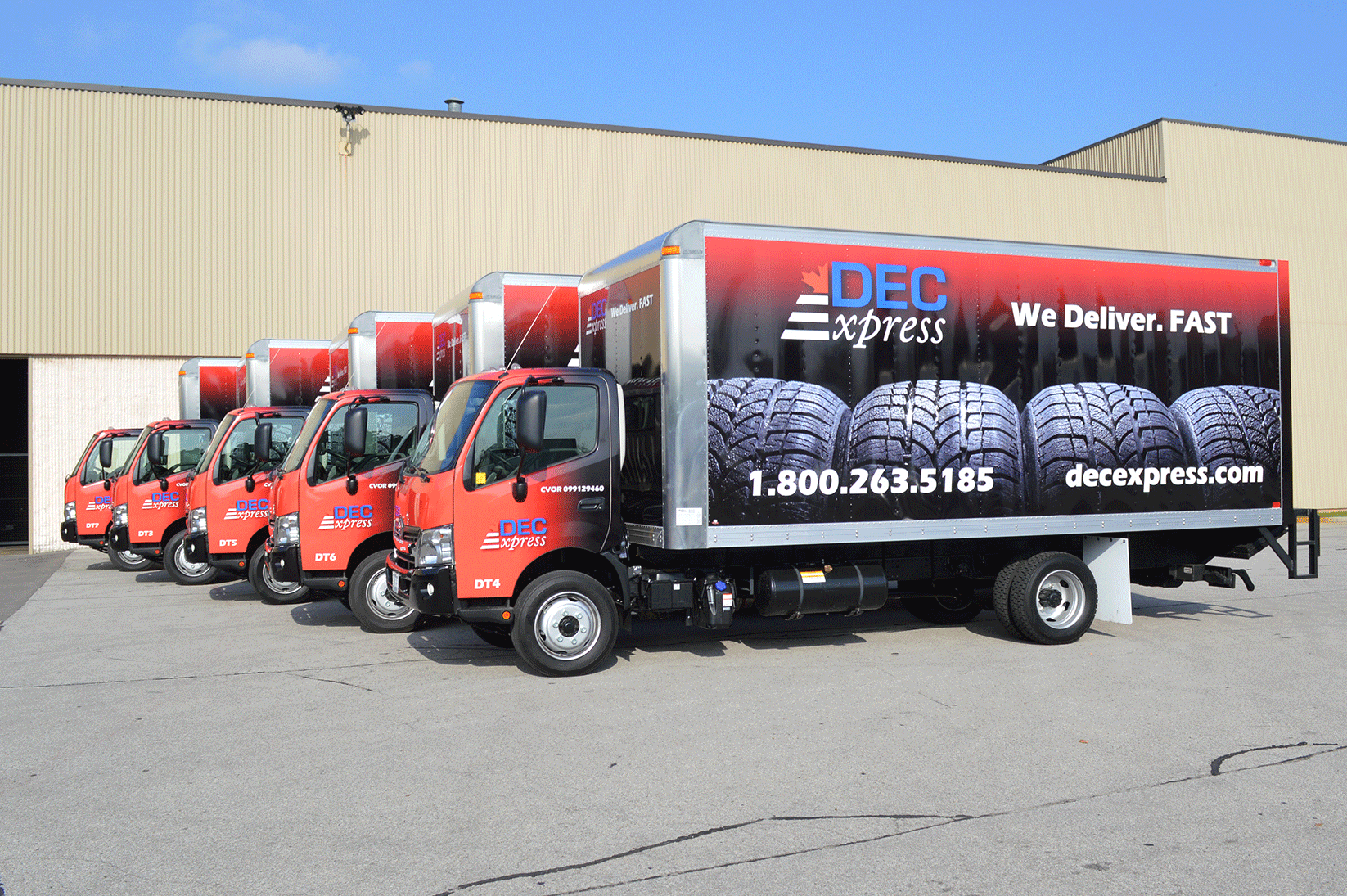 A fleet of cube trucks wrapped in the same fleet graphics to create branding on the company's commercial vehicle fleet