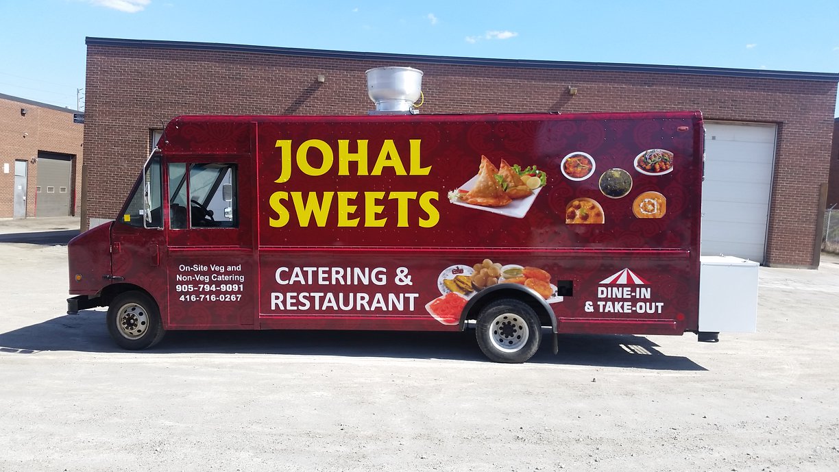 Johal Sweets catering truck wrapped with restaurant branding and food images